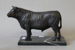 A bronze model of a bull on a plinth base. 24 cm long.