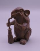 A wooden netsuke formed as a rat. 4.5 cm high.
