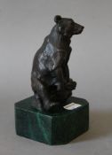 A bronze model of a bear on a marble base. 15 cm high.