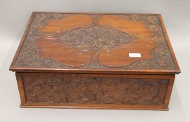 An early 20th century carved walnut box, the lid initialled I.M, the reverse dated December 12-1904.
