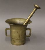 A bronze pestle and mortar. 14 cm high.