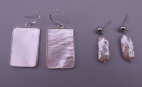 Two pairs of silver and mother-of-pearl earrings. Rectangular pair 3 x 2 cm, other pair 3 cm high.