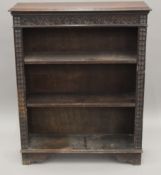 A Victorian carved oak open bookcase. 91 cm wide.