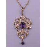 A 9 ct gold amethyst and pearl pendant on a gold chain.
