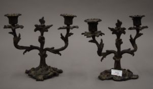 A pair of bronze rococo style candlesticks. 21 cm high.