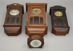 Three late 19th/early 20th century oak wall clocks and a mantle clock. The largest 64 cm high.