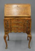 An early 20th century Queen Anne style walnut bureau. 61 cm wide.