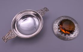 A silver engraved circular Scottish Cairngorm brooch and a white metal quaich. Brooch 6.
