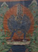 A 19th century Tibetan painted thanka, framed and glazed. 76.5 x 99 cm.