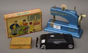 A vintage child's Vulcan sewing machine, a Lotto game and a camera, etc.