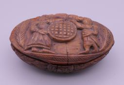 A carved coquilla nut snuff box. Approximately 7 cm wide, 2 cm high.