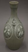 A large Korean porcelain bottle vase of typical palette, signature to base. 38 cm high.