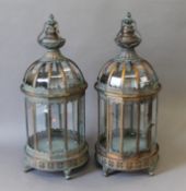 A pair of copper coloured lanterns. 60 cm high.