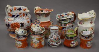 A collection of Masons and other Ironstone jugs and a vase. The largest 23 cm high.