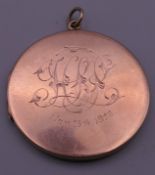 A 9 ct gold locket. 3.5 cm diameter. 11.6 grammes.