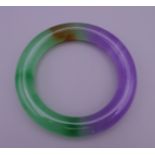 A two tone jade bangle. 6 cm internal diameter.