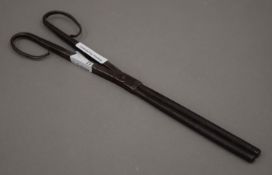 A 17th/18th century pair of steel curling tongs. 26 cm long.