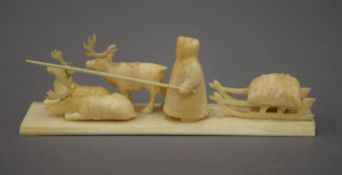 A 19th century North American marine ivory sledge group carving. 15.5 cm long.