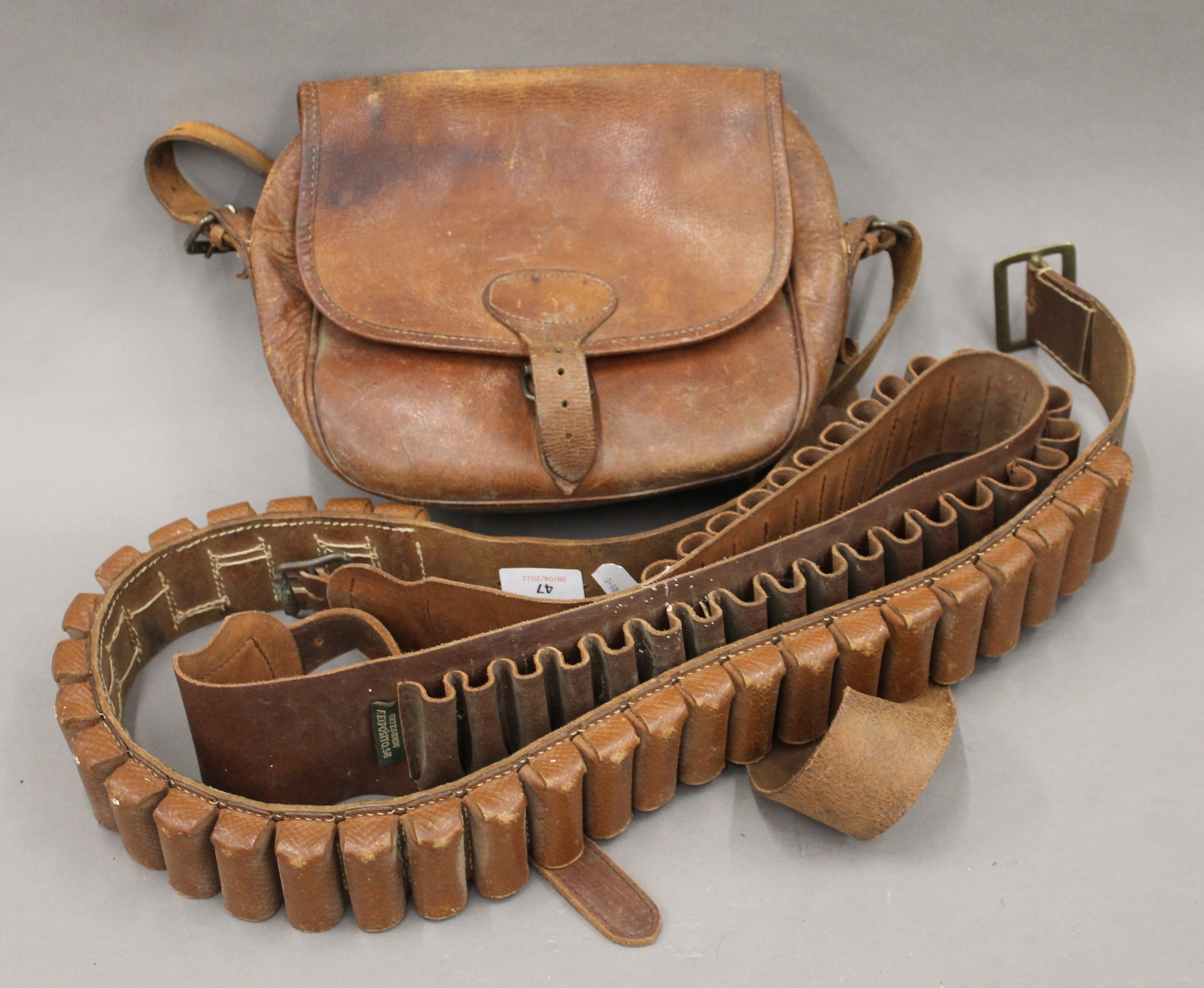 Two leather cartridge belts and a leather cartridge bag.