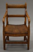 A 19th century elm child's open arm chair. 33.5 cm wide.