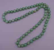 A string of jade beads. 85 cm long.