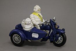 A cast iron Michelin man on a motorcycle with side car. 22 cm long.