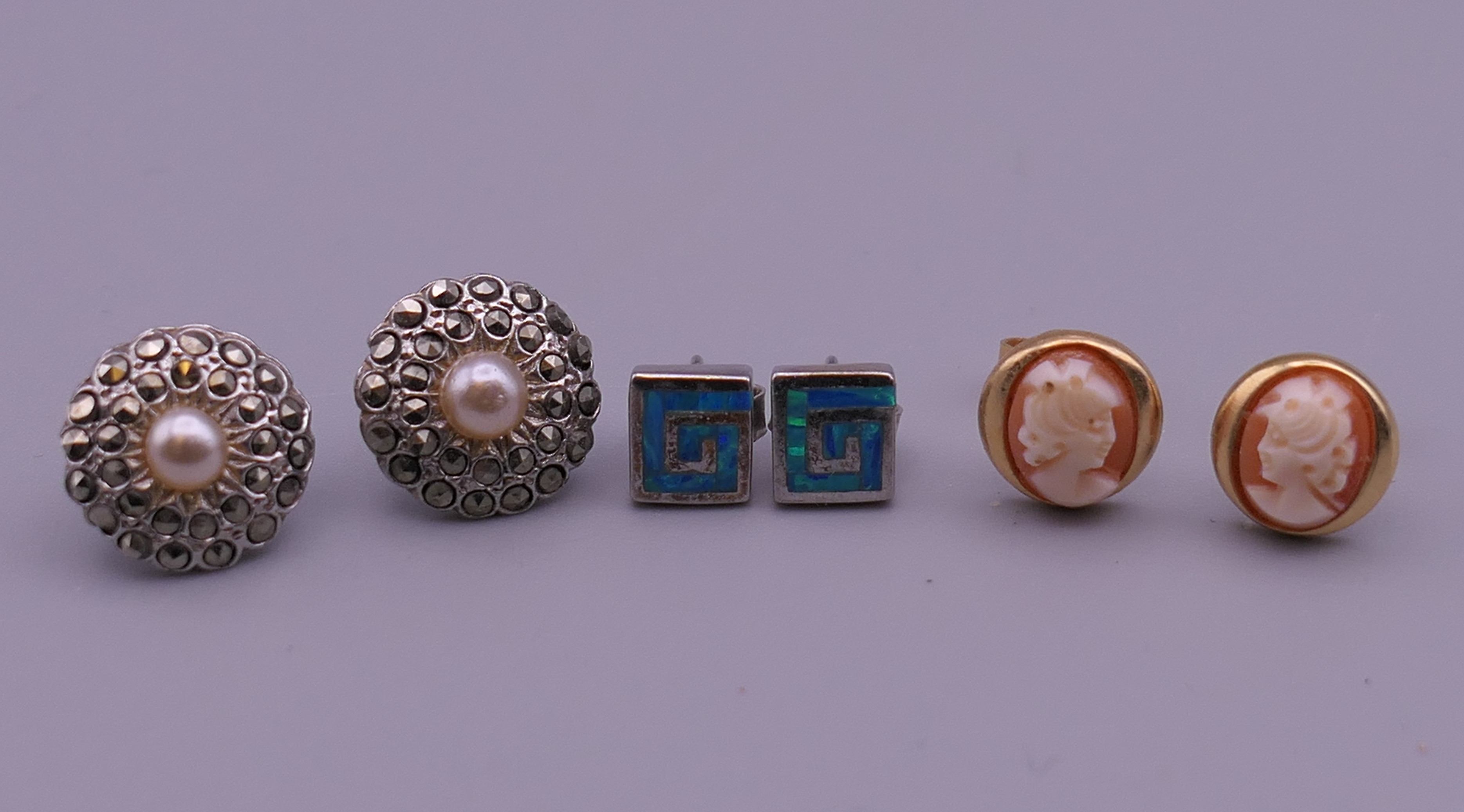 Three pairs of earrings. Cameo earrings 1 cm high.