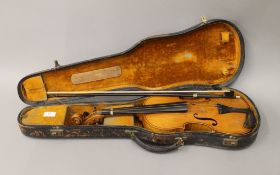 An early 20th century violin and bow, in a W E Hills & Sons case. 59 cm long.