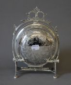 A silver plated circular engraved biscuit box. 22 cm high.