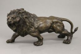 A bronze model of a lion. 31 cm long.