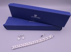 A Swarovski crystal leaf pattern bracelet and a pair of Swarovski earrings,