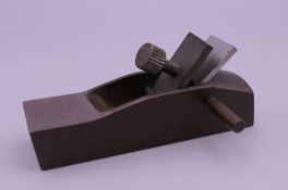 A bronze model of a woodworking plane. 8.5 cm long.