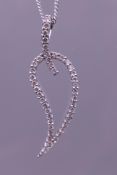 A contemporary 18 ct white gold and diamond pendant modelled as an open leaf,