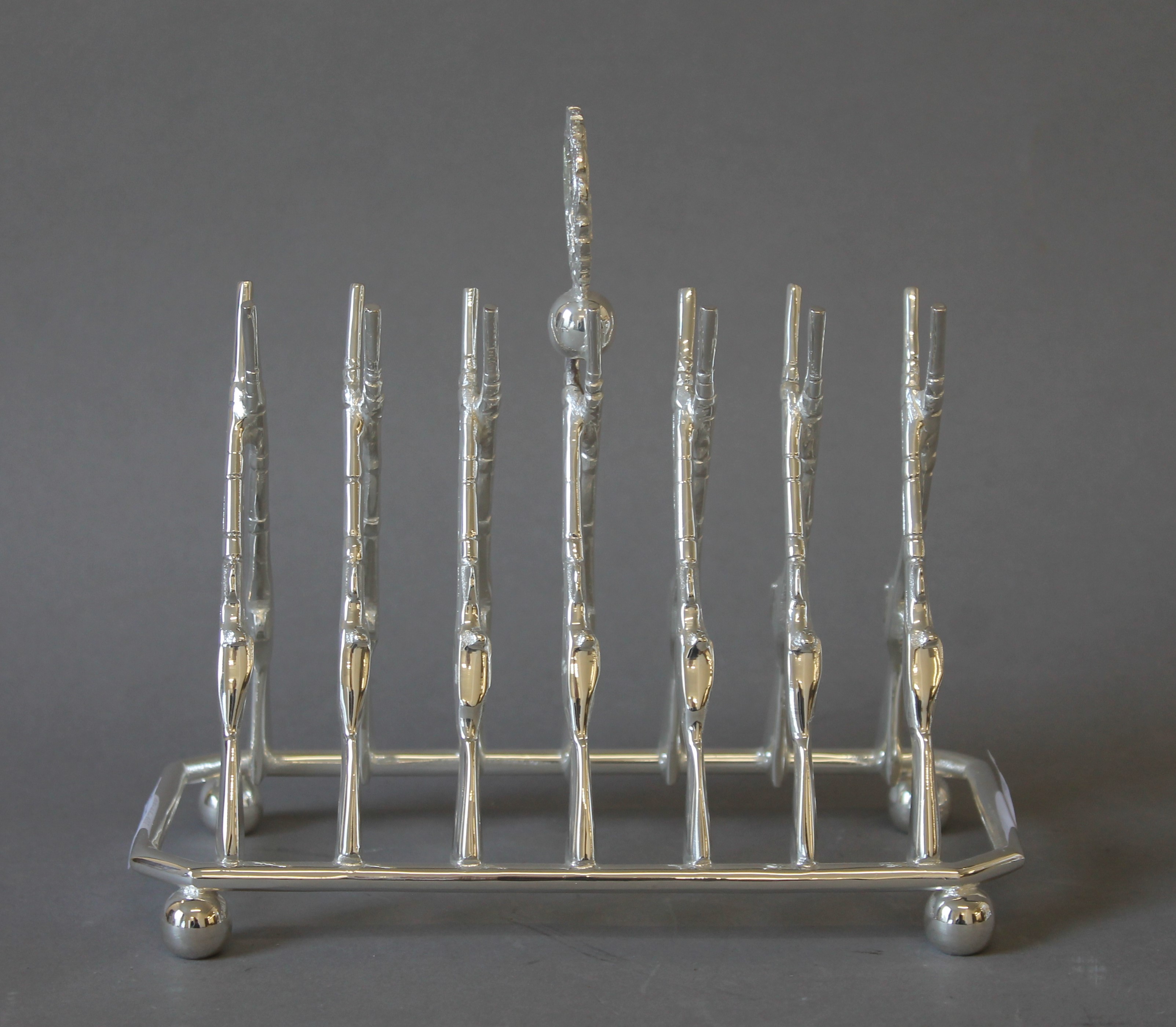 A silver plated rifle form toast rack.
