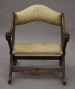 A 19th century Continental carved walnut x-frame chair. 62.5 cm wide.