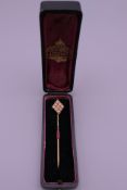 Am 18 ct gold seed pearl stick pin, boxed. 6.5 cm long. 2.5 grammes total weight.