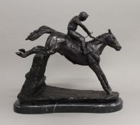 A model of a horse and jockey on a plinth base. 32.5 cm high.