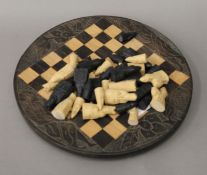 A chess set and board. The board 32 cm diameter.