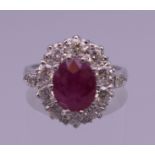 A platinum ruby and diamond ring. Ring size N/O. 6.6 grammes total weight.