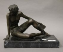 A bronze model of a scantily clad male.