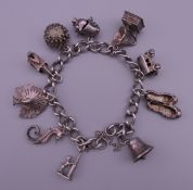 A silver charm bracelet. Approximately 18 cm long. 43.6 grammes.