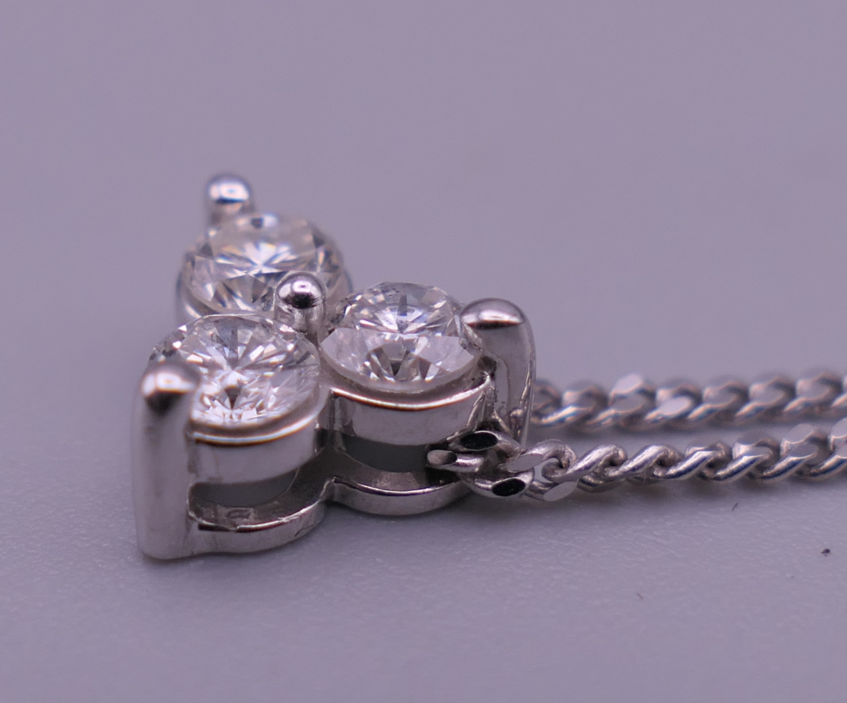 An 18 ct white gold and diamond necklace and pendant and a pair of matching earrings. - Image 4 of 8
