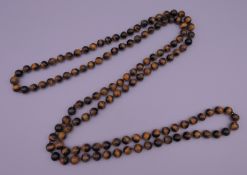 A string of tigers eye beads. 120 cm long.