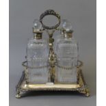 A Georgian silver decanter stand, set with four associated silver collard cut glass decanters.