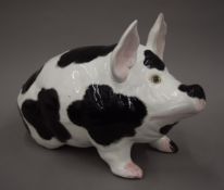 A large Wemyss porcelain model of a pig. 28 cm high, 40 cm long, 18 cm wide.