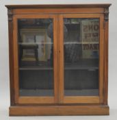 A Victorian glazed walnut bookcase. 107 cm wide.