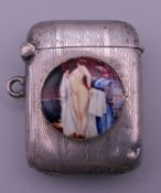 A silver vesta decorated with a nude woman. 3.75 x 3 cm.