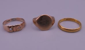 Two 9 ct gold rings (5.9 grammes total weight) and a 22 ct gold ring (2.8 grammes).