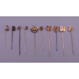 Ten vintage gold stick pins. Largest 6.5 cm long.