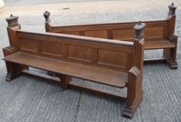 A pair of Victorian carved oak pews, each carved with crown form ends and with various family names.